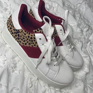 white cheetah and red sneakers
